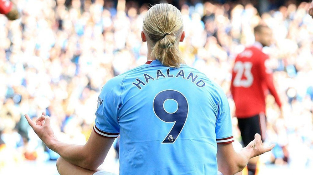 Erling Haaland performing his iconic cross-legged meditation celebration after scoring